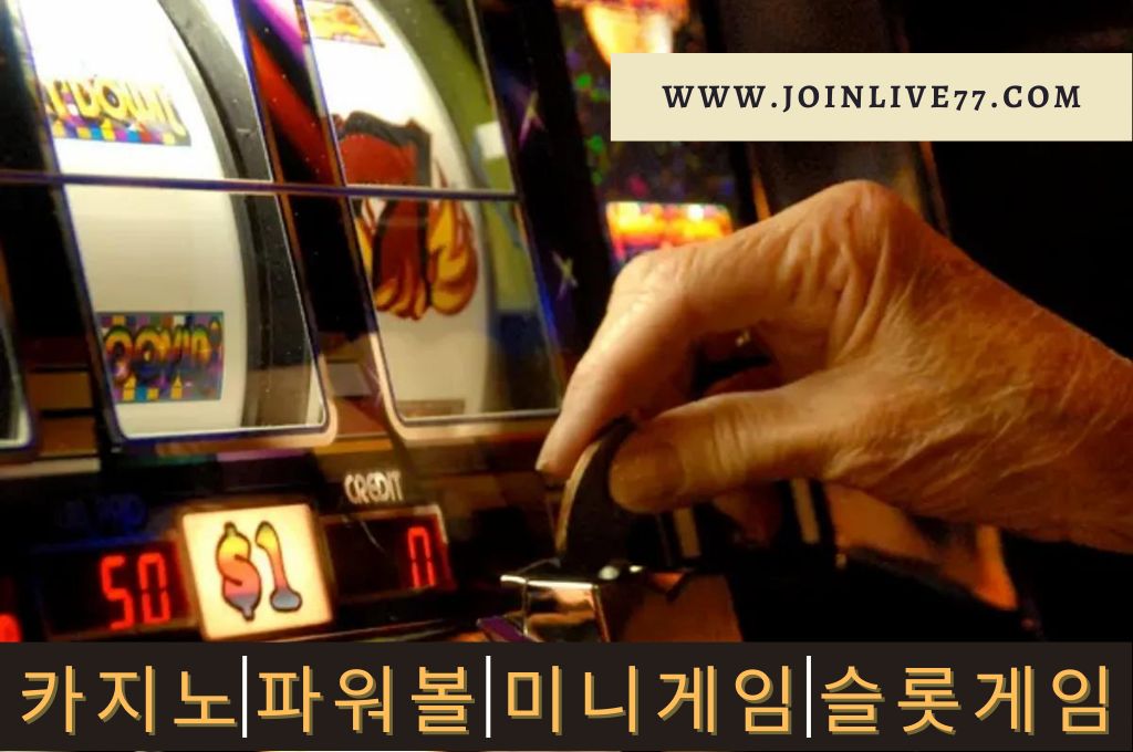 Old woman hand inserting coin in slot machine to play.